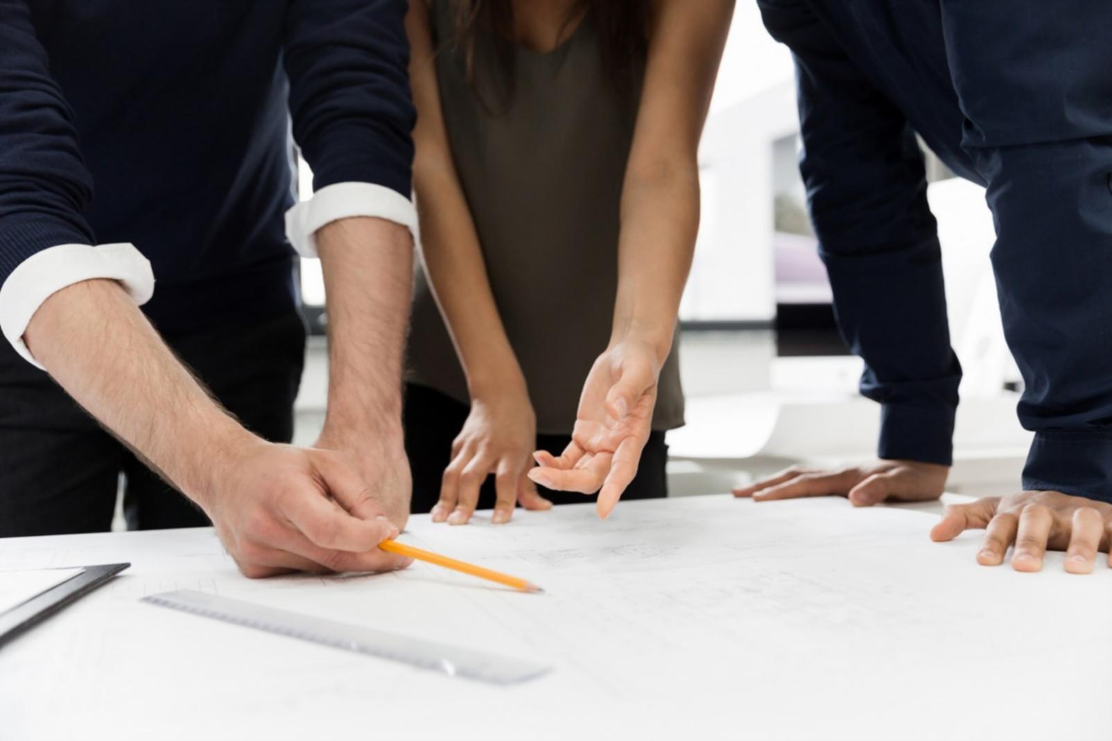 Professional consultant reviewing business reports with client